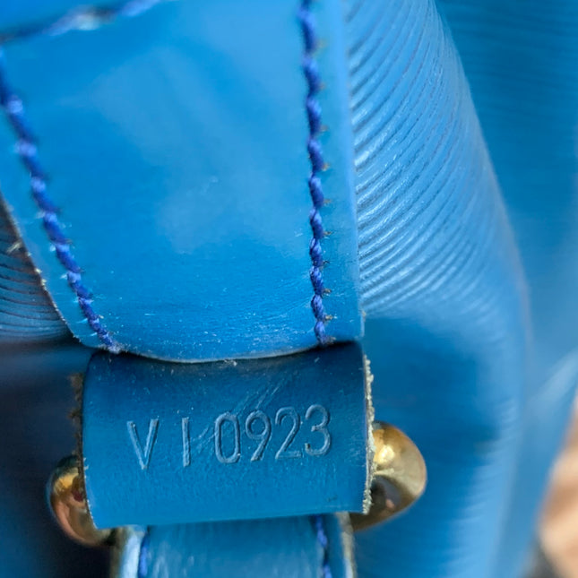 Blue Louis Vuitton Epi Noe GM Bucket Bag. The Noe GM features blue epi leather body, an adjustable leather shoulder strap, and an open top with a drawstring closure.
